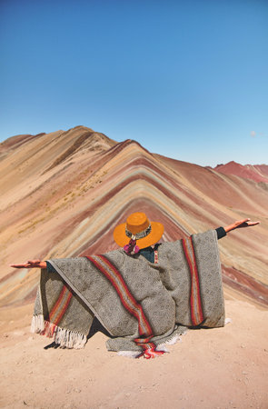 Young girl enjoying in front of the Vinicunca Rainbow Mountain, Peru South Americaの写真素材