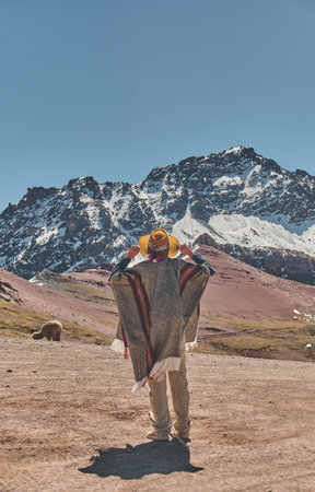 Young girl in front of the Ausangate mountain in Peru with all the Andes mountains in the background.の写真素材