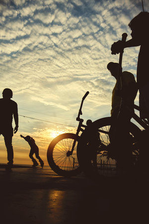 Skateboarding and BMX bike Silhouette Extreme Skatepark Images Orange Sunlight Youth Culture Enjoy...