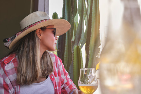 woman drinking beer and enjoying summer day, Mexican bar