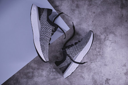 Grey sneakers isolated on a concrect background, Concept healthy lifestyle outfit, sport and diet....