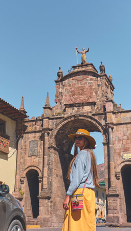 Tourist woman walking with backpack on the street in Cusco, Peru. Copy space