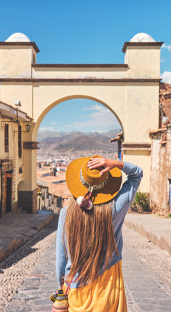 Young latin female traveler wearing sunglasses with a backpack against a brick building Hiking and travel concept Copy spaceの写真素材