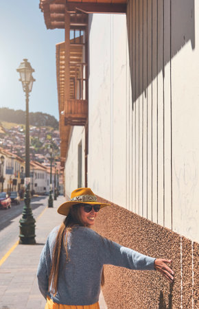 Tourist woman walking with backpack on the street in Cusco, Peru. Copy spaceの写真素材