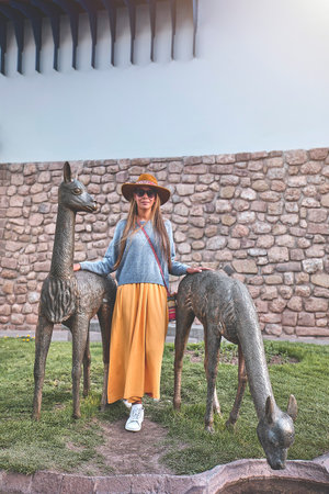 Tourist woman walking with backpack on the street in Cusco, Peru. Copy space