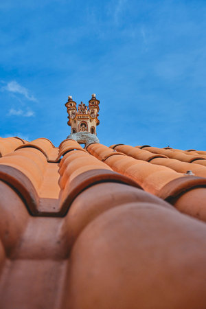 A building with a red roof and a tower on top, Ayacucho, Peru, View of the quinua little town detail in the house roofの写真素材