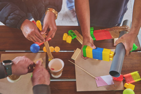 Team building activities in the office with sticks.Concept of friendship, teambuilding and teamwork.