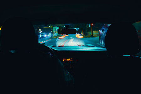 A couple is driving in a car at night, motion blur