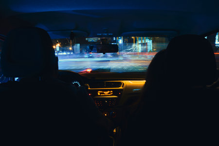 A couple is driving in a car at night, motion blurの写真素材