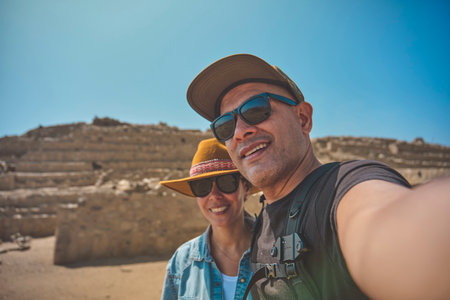 Young couple in archaeological site of the Sacred City of Caral, Peru.の写真素材