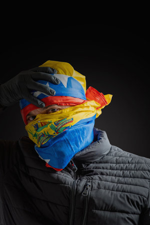 Concept symbol of repression, hooded fighting for freedom, resistance for democracy in Venezuela, violation of human rightsの写真素材
