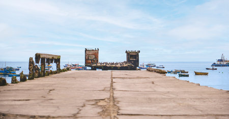 A pier with a few boats docked in the water, Chancay Lima, Peru.