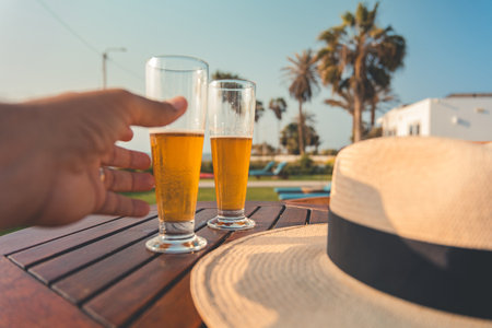 A person is holding a glass of beer, relax conceptの写真素材