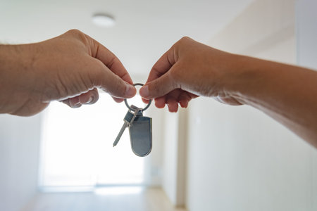 Two people holding keys in their hands. New home concept.