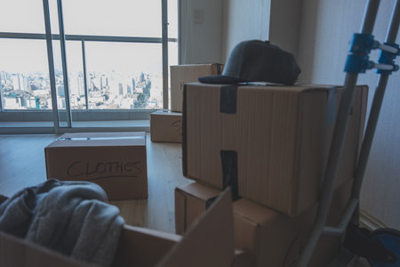 A room full of boxes with the word Clothes on them. New home concept.