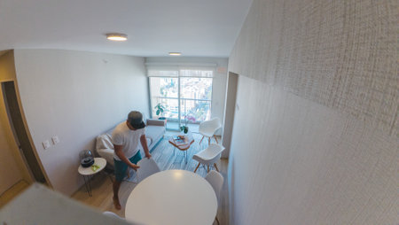 A man is standing in front of a white table with a white tablecloth. New home concept.の写真素材