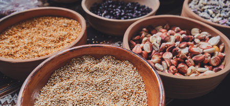 Various dried spices, andean cereals and grains in small bowls and raw herbs.の写真素材