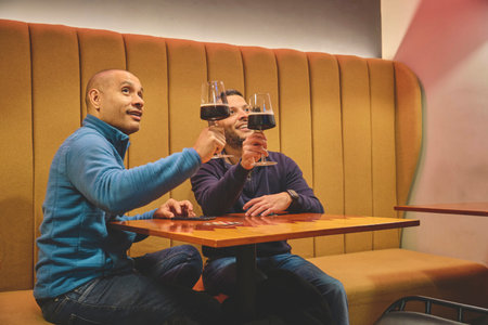 Two men enjoying craft beer at a cozy bar, cheers