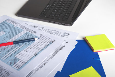 Accountant calculating taxes using laptop, Tax concept