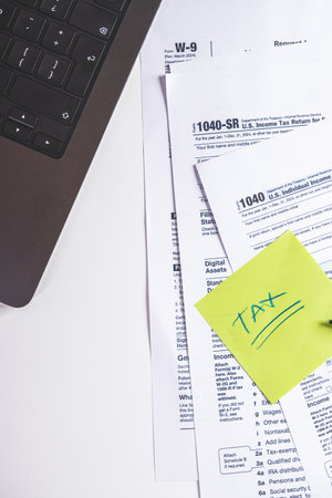 Accountant preparing tax form 1040 for tax season 2025の写真素材