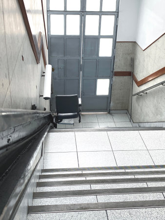 Stairlift helping people with reduced mobility navigate building accessibilityの写真素材