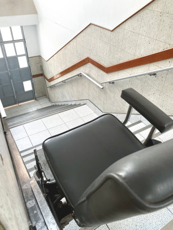Stairlift going up the stairs in a modern buildingの写真素材
