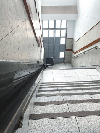 Stairlift providing accessibility for people with mobility issues in building entranceの写真素材