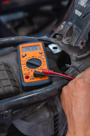 Mechanic checking motorcycle electrical systemの写真素材