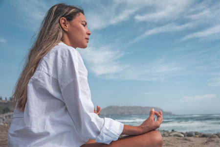 Young woman relax on beach yoga mat during summer vacationの写真素材