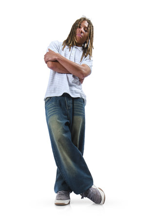 Young man with dreadlocks standing with arms crossed on a white backgroundの写真素材
