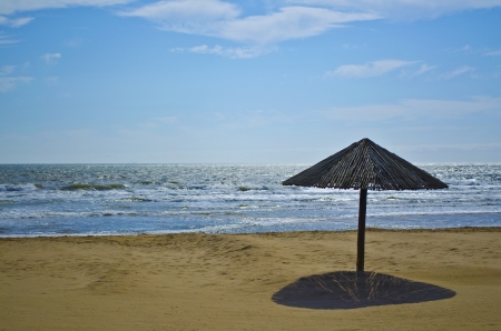 Wooden beach umbrella on the Indian Ocean coast at Durbanの写真素材