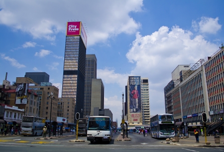 JOHANNESBURG - MARCH 10: Buses move out of Ghandi Sqaure in Johannesburg on March 10, 2013 in Johannesburg.  The bus terminal is named after Mahatma Ghandi.のeditorial素材