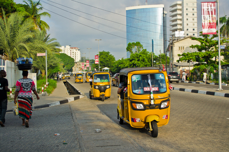Lagos, Nigeria - May 20, 2016: Tuk tuk drivers transport their passengers around the port city of Lagos on May 20, 2016 in Lagos, Nigeria. Lagos port is responsible for processing 80% of imports into Nigeria.のeditorial素材