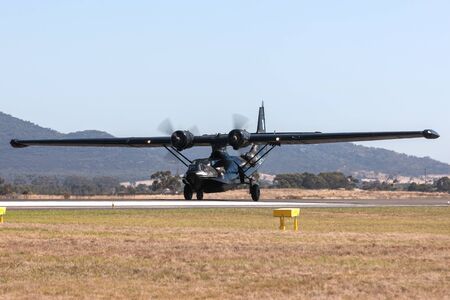 Avalon, Australia - March 2, 2013: Consolidated PBY Catalina Flying boat VH-PBZ wearing the famous Black Cats livery from the Royal Australian Air Force during World War II.のeditorial素材