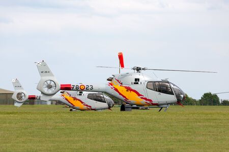 RAF Waddington, Lincolnshire, UK - July 6, 2014: Spanish Air Force (Ejercito del Aire) Eurocopter EC-120B Colibri helicopter from the Patrulla Aspa display team performing an aerial display at an airshow.のeditorial素材