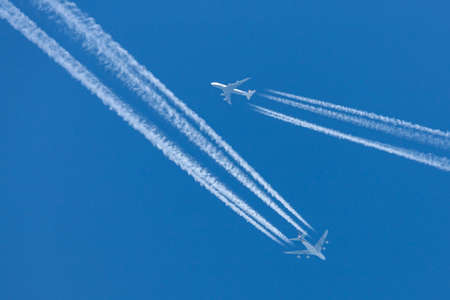 RAF Fairford, Gloucestershire, UK - July 10, 2014: Singapore Airlines Airbus A380 flying at cruising altitude with a Lufthansa Boeing 747 flying in close proximity.のeditorial素材