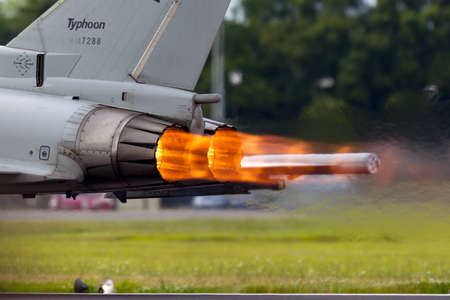 RAF Fairford, Gloucestershire, UK - July 14, 2014: Glowing hot afterburners of Italian Air Force Eurofighter Typhoon aircraft as it accelerates down the runway.のeditorial素材