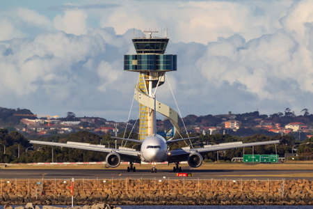 Sydney, Australia - October 8, 2013: Singapore Airlines Boeing 777 aircraft taxiâs after landing at Sydney Airport with the air traffic control tower in the background.のeditorial素材