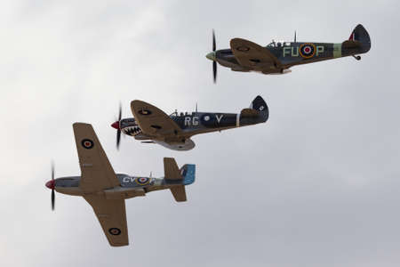 Temora, Australia - November 2, 2013: Commonwealth Aircraft Corporation CA-18 Mustang (North American P-51D Mustang) in flying formation with two Supermarine Spitfires.のeditorial素材