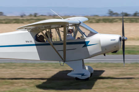 Lethbridge, Australia - November 23, 2014: Piper PA-11 Cub Special single engine light aircraft taking off from a country airfield.のeditorial素材