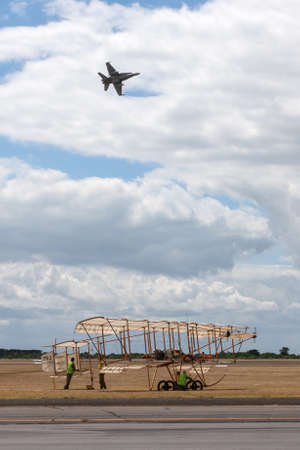 RAAF Williams, Point Cook, Australia - December 6, 2013: Bristol Boxkite vintage aircraft VH-XKT at the home of military aviation in Australia RAAF Williams, Point Cook with a Royal Australian Air Force McDonnell Douglas F/A-18A Flying overhead.のeditorial素材