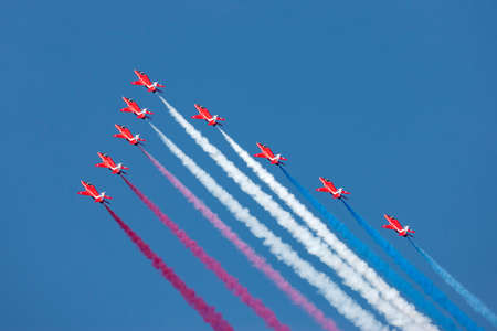Farnborough, UK - July 19, 2014:  Royal Air Force (RAF) Red Arrows formation aerobatic display team flying British Aerospace Hawk T.1 Jet trainer aircraft.のeditorial素材