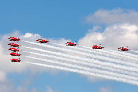 Farnborough, UK - July 17, 2014:  Royal Air Force (RAF) Red Arrows formation aerobatic display team flying British Aerospace Hawk T.1 Jet trainer aircraft.のeditorial素材