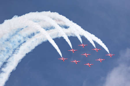 RAF Fairford, Gloucestershire, UK - July 13, 2014: Royal Air Force (RAF) Red Arrows formation aerobatic display team flying British Aerospace Hawk T.1 Jet trainer aircraft.のeditorial素材