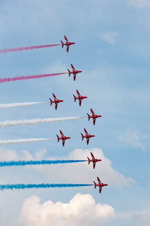 RAF Fairford, Gloucestershire, UK - July 12, 2014: Royal Air Force (RAF) Red Arrows formation aerobatic display team flying British Aerospace Hawk T.1 Jet trainer aircraft.のeditorial素材