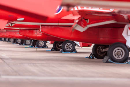RAF Fairford, Gloucestershire, UK - July 11, 2014: Landing gear of Royal Air Force (RAF) Red Arrows display team British Aerospace Hawk T.1 Jet trainer aircraft parked in a line.のeditorial素材