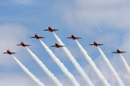 RAF Fairford, Gloucestershire, UK - July 10, 2014: Royal Air Force (RAF) Red Arrows formation aerobatic display team flying British Aerospace Hawk T.1 Jet trainer aircraft.のeditorial素材