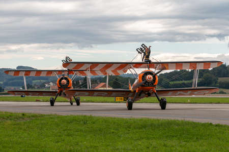 Payerne, Switzerland - August 31, 2014: Breitling Wing walkers barnstorming flying display in vintage Boeing Stearman biplanes.のeditorial素材