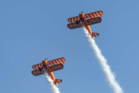 Payerne, Switzerland - September 6, 2014: Breitling Wing walkers barnstorming flying display in vintage Boeing Stearman biplanes.のeditorial素材