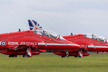 RAF Waddington, Lincolnshire, UK - July 6, 2014: Royal Air Force (RAF) Red Arrows formation aerobatic display team flying British Aerospace Hawk T.1 Jet trainer aircraft.のeditorial素材
